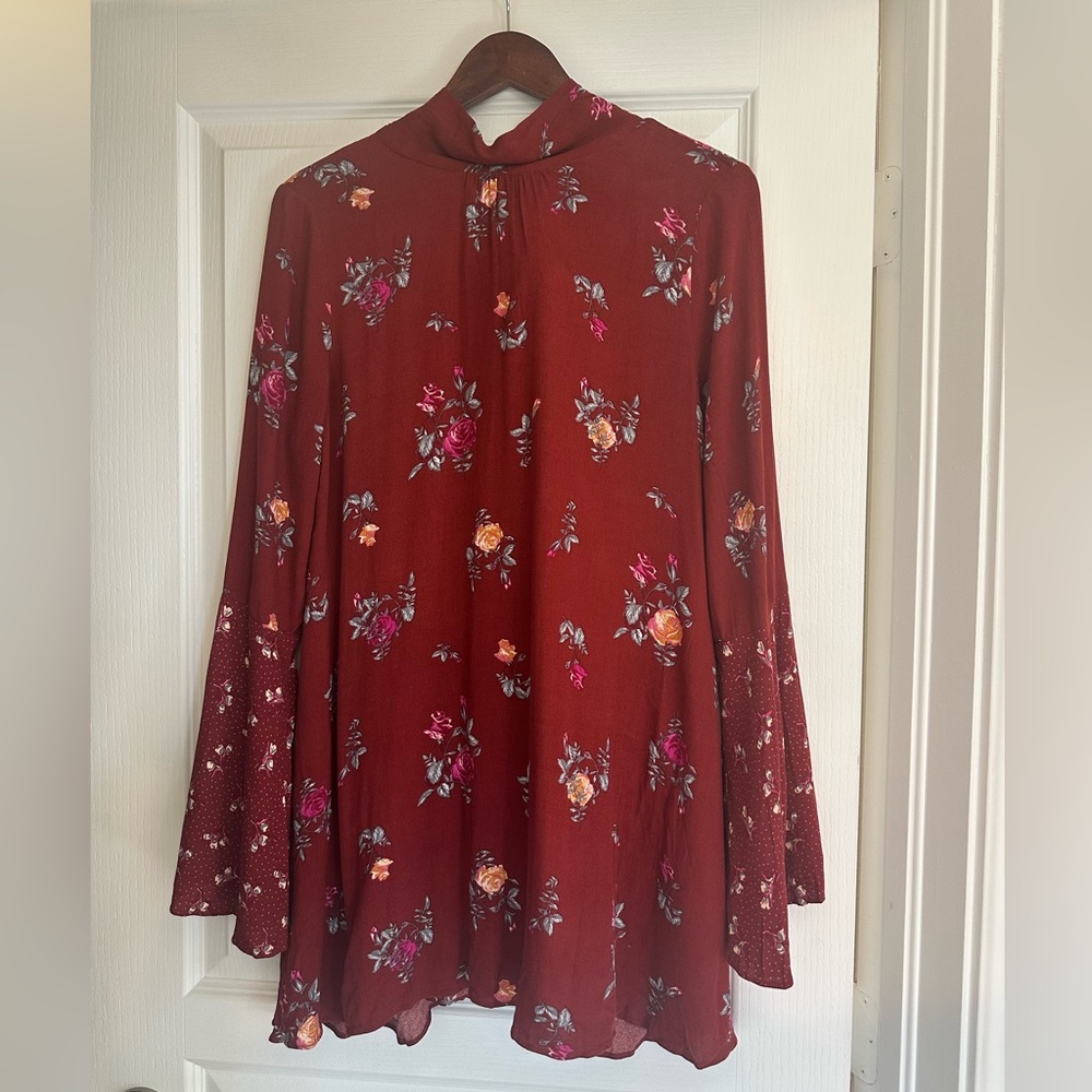 Free people dress burgundy with flower design. Bell hands
